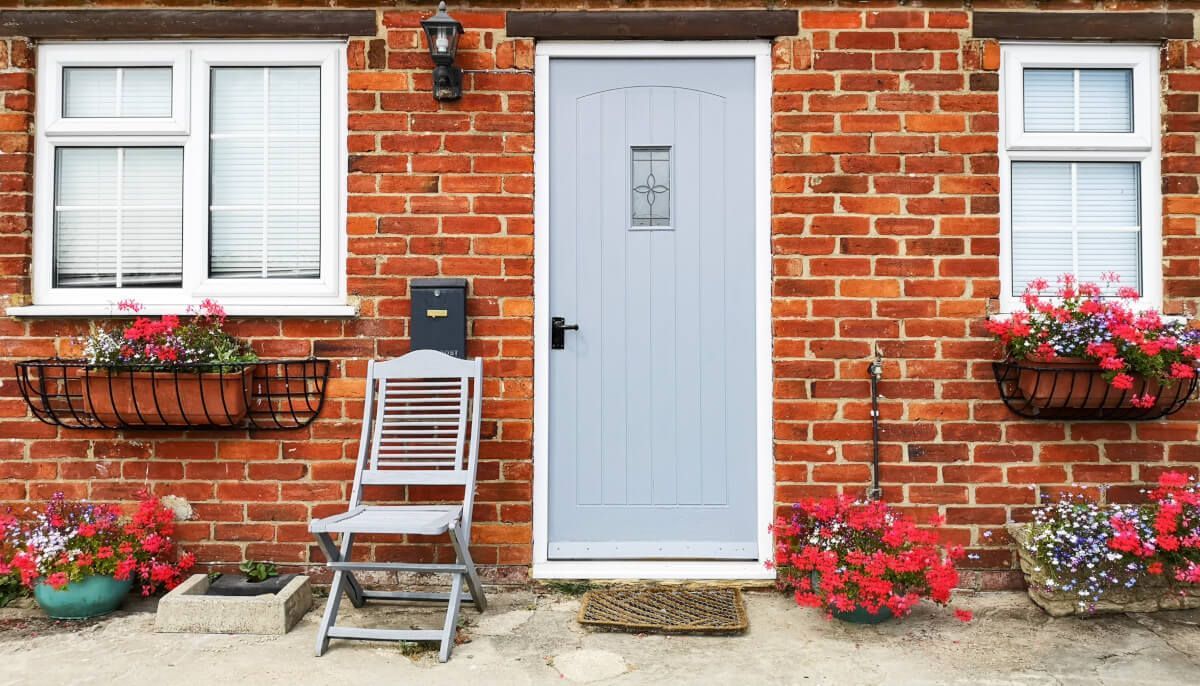 pale blue door red brick house
