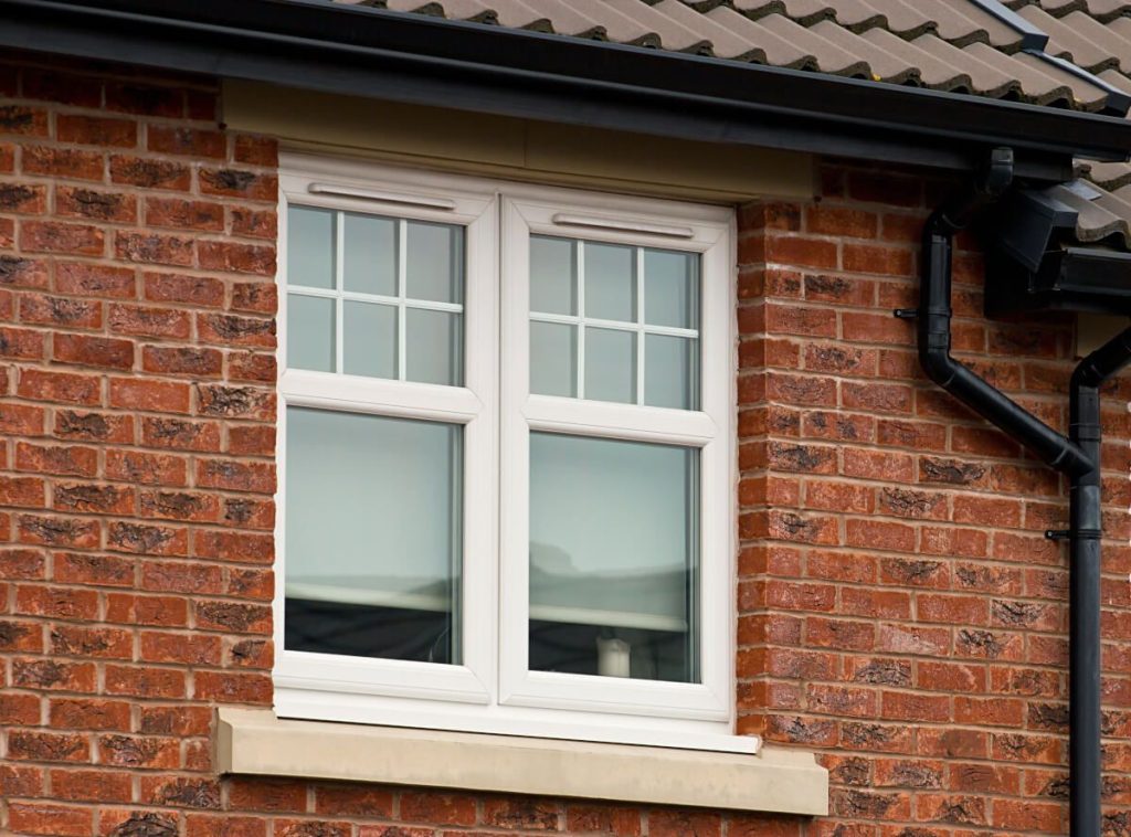 White casement window red brick house